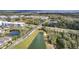 Aerial view of a community featuring a pedestrian bridge, lakes, natural preserve, and newly constructed residences at 338 Wooded Vine Dr, Winter Springs, FL 32708
