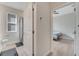 Neutral-toned bathroom featuring a shower/tub combo and access from a bedroom with matching neutral walls and floors at 338 Wooded Vine Dr, Winter Springs, FL 32708