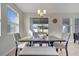 Sunlit dining area featuring a wooden table, cushioned seating, and sliding glass doors leading to the outdoors at 338 Wooded Vine Dr, Winter Springs, FL 32708