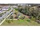 Aerial view of a dog park with multiple fenced areas, mature trees, shelters, and walking trails in a park-like setting at 338 Wooded Vine Dr, Winter Springs, FL 32708