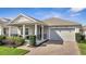 Charming single-story home featuring a covered front porch and a two-car garage at 338 Wooded Vine Dr, Winter Springs, FL 32708