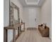 Bright foyer with light floors, stylish mirror, decorative table, and a wooden bench with storage near the front door at 338 Wooded Vine Dr, Winter Springs, FL 32708