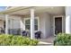 Comfortable covered front porch with seating and manicured landscaping leading to the front door at 338 Wooded Vine Dr, Winter Springs, FL 32708
