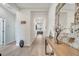 Long hallway with light-toned wood-look flooring, neutral walls, and decorative wall art, leading to the living area at 338 Wooded Vine Dr, Winter Springs, FL 32708