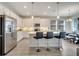 Bright, modern kitchen featuring white cabinets, stainless steel appliances, and an island with seating for three at 338 Wooded Vine Dr, Winter Springs, FL 32708