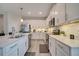 Bright, modern kitchen with white cabinets, stainless steel appliances, and a functional layout for cooking at 338 Wooded Vine Dr, Winter Springs, FL 32708