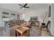 Comfortable living room with large sectional sofa, ceiling fan, and stylish area rug creating an inviting atmosphere at 338 Wooded Vine Dr, Winter Springs, FL 32708
