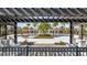 This aerial shows a resort-style community pool with palm trees, lounge chairs, tables and decorative pergolas at 338 Wooded Vine Dr, Winter Springs, FL 32708