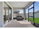 Relaxing screened-in porch with comfortable seating and views of the backyard through large windows at 338 Wooded Vine Dr, Winter Springs, FL 32708