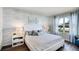 Serene bedroom featuring a queen bed, textured wallpaper, and lots of natural light at 3715 Bluethread Way, Poinciana, FL 34759