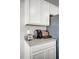 Kitchen featuring white cabinets, stainless steel refrigerator, and a convenient coffee station on the countertop at 3715 Bluethread Way, Poinciana, FL 34759