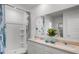 Well-lit bathroom with double sinks, granite counters, a walk-in shower, and ample storage space at 3719 Bluethread Way, Poinciana, FL 34759