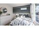 Sunlit bedroom showcasing a bed with stylish bedding, a round mirror, and a large window at 3719 Bluethread Way, Poinciana, FL 34759