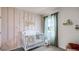 Adorable Bedroom with a crib, soft color palette, and a charming accent wall at 3719 Bluethread Way, Poinciana, FL 34759