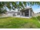 Lawn featuring a screened-in porch, shed, brick patio, and fenced yard at 4051 Prairie Reserve Blvd, Orlando, FL 32824
