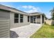 Backyard showcasing a brick patio, shed, and screened-in porch, creating an inviting outdoor space at 4051 Prairie Reserve Blvd, Orlando, FL 32824