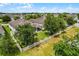 Aerial view of a backyard with white picket fence, screen porch, and well-manicured lawn at 4051 Prairie Reserve Blvd, Orlando, FL 32824