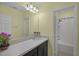 Well-lit bathroom with a spacious countertop, dark wood cabinets, and a shower-tub combo at 4051 Prairie Reserve Blvd, Orlando, FL 32824