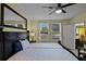 Bedroom with two beds, a ceiling fan, and a view of the backyard through the windows at 4051 Prairie Reserve Blvd, Orlando, FL 32824