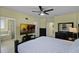 Bedroom features a ceiling fan, mounted TV, and an attached bathroom with a tub at 4051 Prairie Reserve Blvd, Orlando, FL 32824