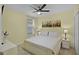 Cozy bedroom with a ceiling fan, soft lighting, and a comfortable bed with cityscape art at 4051 Prairie Reserve Blvd, Orlando, FL 32824