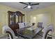 Dining area featuring tile floors, a modern ceiling fan, and a decorative china cabinet at 4051 Prairie Reserve Blvd, Orlando, FL 32824