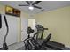 Bright exercise room with a ceiling fan, treadmill, and elliptical machine for home workouts at 4051 Prairie Reserve Blvd, Orlando, FL 32824