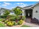 Lovely single-story home with vibrant landscaping and a welcoming front entrance with brick pathway at 4051 Prairie Reserve Blvd, Orlando, FL 32824