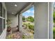 Covered front porch with brick flooring and overhead lighting; features columns and seating at 4051 Prairie Reserve Blvd, Orlando, FL 32824