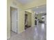 Hallway with tile flooring, light yellow walls, and a view of the dining area and Gathering room at 4051 Prairie Reserve Blvd, Orlando, FL 32824