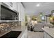 Bright kitchen with stainless appliances, granite counters and views to living area at 4051 Prairie Reserve Blvd, Orlando, FL 32824