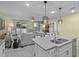 Open concept kitchen flows to living area, perfect for entertaining with island seating at 4051 Prairie Reserve Blvd, Orlando, FL 32824