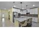 Bright kitchen with stainless appliances, granite counters, breakfast bar and tile flooring at 4051 Prairie Reserve Blvd, Orlando, FL 32824