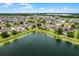 Scenic aerial view of the community and the lake, surrounded by lush greenery and residences at 4051 Prairie Reserve Blvd, Orlando, FL 32824