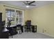Bright office space featuring tile floors, a ceiling fan, and a work area with natural light at 4051 Prairie Reserve Blvd, Orlando, FL 32824