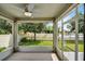 Relax on screened porch featuring a peaceful view of the fenced yard and lake at 4051 Prairie Reserve Blvd, Orlando, FL 32824