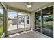 Enjoy the screened-in porch, showcasing backyard access and a view of the lawn and shed at 4051 Prairie Reserve Blvd, Orlando, FL 32824