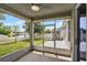 Screened-in porch offering a view of the lake, backyard shed, and fenced yard at 4051 Prairie Reserve Blvd, Orlando, FL 32824