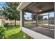 Screened-in porch with a view of the spacious backyard, shed, and lake beyond the fence at 4051 Prairie Reserve Blvd, Orlando, FL 32824