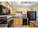 Well-equipped kitchen featuring wooden cabinets, black appliances, and laminate countertops at 485 Forestway Cir # 108, Altamonte Springs, FL 32701
