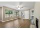 Bright living room features wood floors, a ceiling fan and natural light, with a fireplace on the far right at 485 Forestway Cir # 108, Altamonte Springs, FL 32701