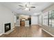 Spacious living room with a fireplace, ceiling fan, and an open view of the kitchen at 485 Forestway Cir # 108, Altamonte Springs, FL 32701