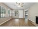 Bright living room features wood floors, a ceiling fan and natural light, with a fireplace on the far right at 485 Forestway Cir # 108, Altamonte Springs, FL 32701