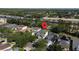 Community aerial view highlighting a home's location near roadways, featuring a private pool, mature trees and solar panels at 5007 Bellthorn Dr, Orlando, FL 32837