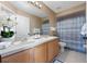 Well-lit bathroom featuring double sinks and shower with blue accents at 5007 Bellthorn Dr, Orlando, FL 32837