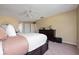 Spacious bedroom with a ceiling fan, dresser, and two entry doors at 5007 Bellthorn Dr, Orlando, FL 32837