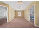 Neutral bonus room featuring a ceiling fan, carpet, and two doorway entrances at 5007 Bellthorn Dr, Orlando, FL 32837