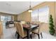 Elegant dining area with modern table and chairs, decorative lighting, and views of the backyard and living area at 5007 Bellthorn Dr, Orlando, FL 32837