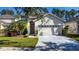 Charming two-story home with manicured lawn, mature landscaping, and attached two-car garage in a well-maintained neighborhood at 5007 Bellthorn Dr, Orlando, FL 32837