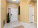 Inviting foyer features tiled flooring, neutral paint, an arched doorway, and decorative accents creating an elegant entry at 5007 Bellthorn Dr, Orlando, FL 32837